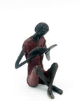 Bronze assis à poser 25 cm rouge n°2 Bronzes d'Afrique